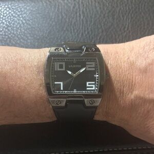 Unlisted by Kennth Cole. Black and Gunmetal Grey. Genuine Leather Band.